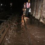 Workers removing debris and junk from flooded tracks